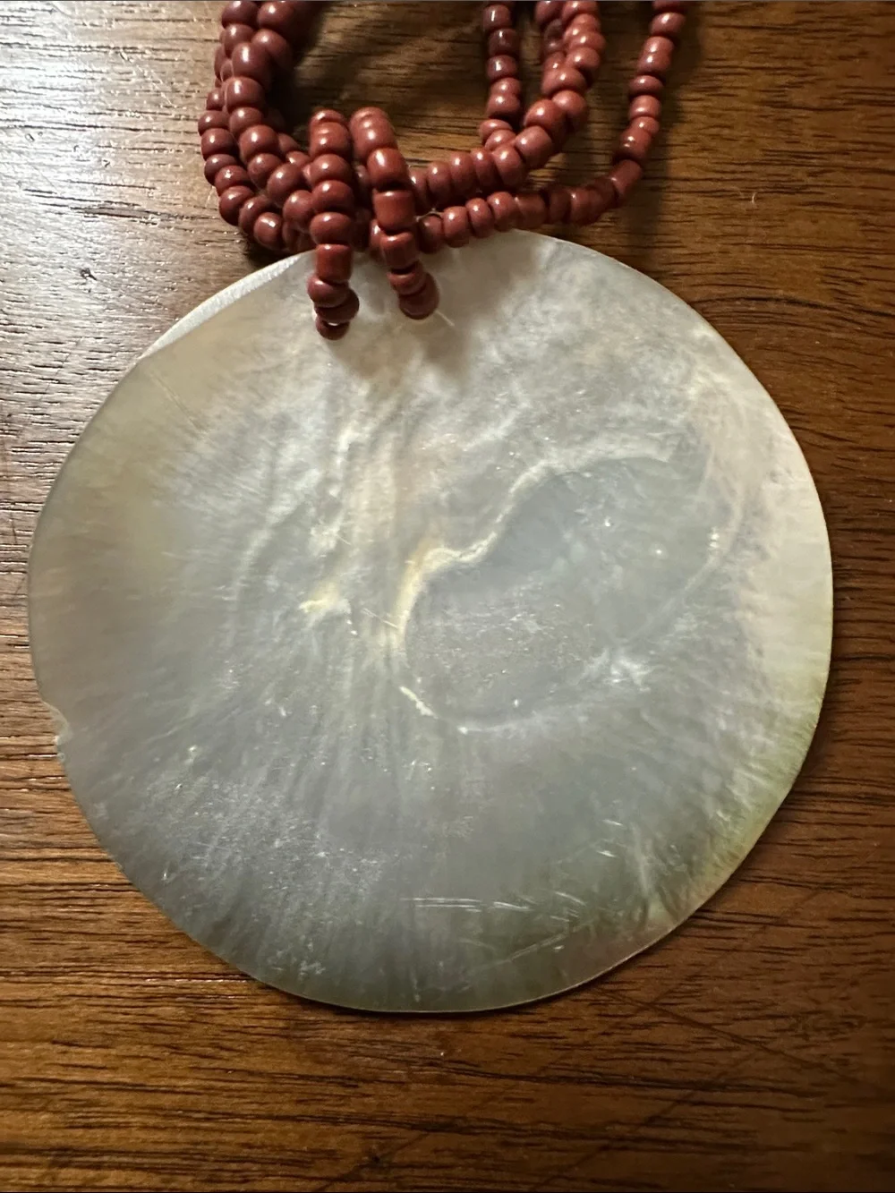 Multi-Strand Red Beaded Necklace with Iridescent Shell Pendant